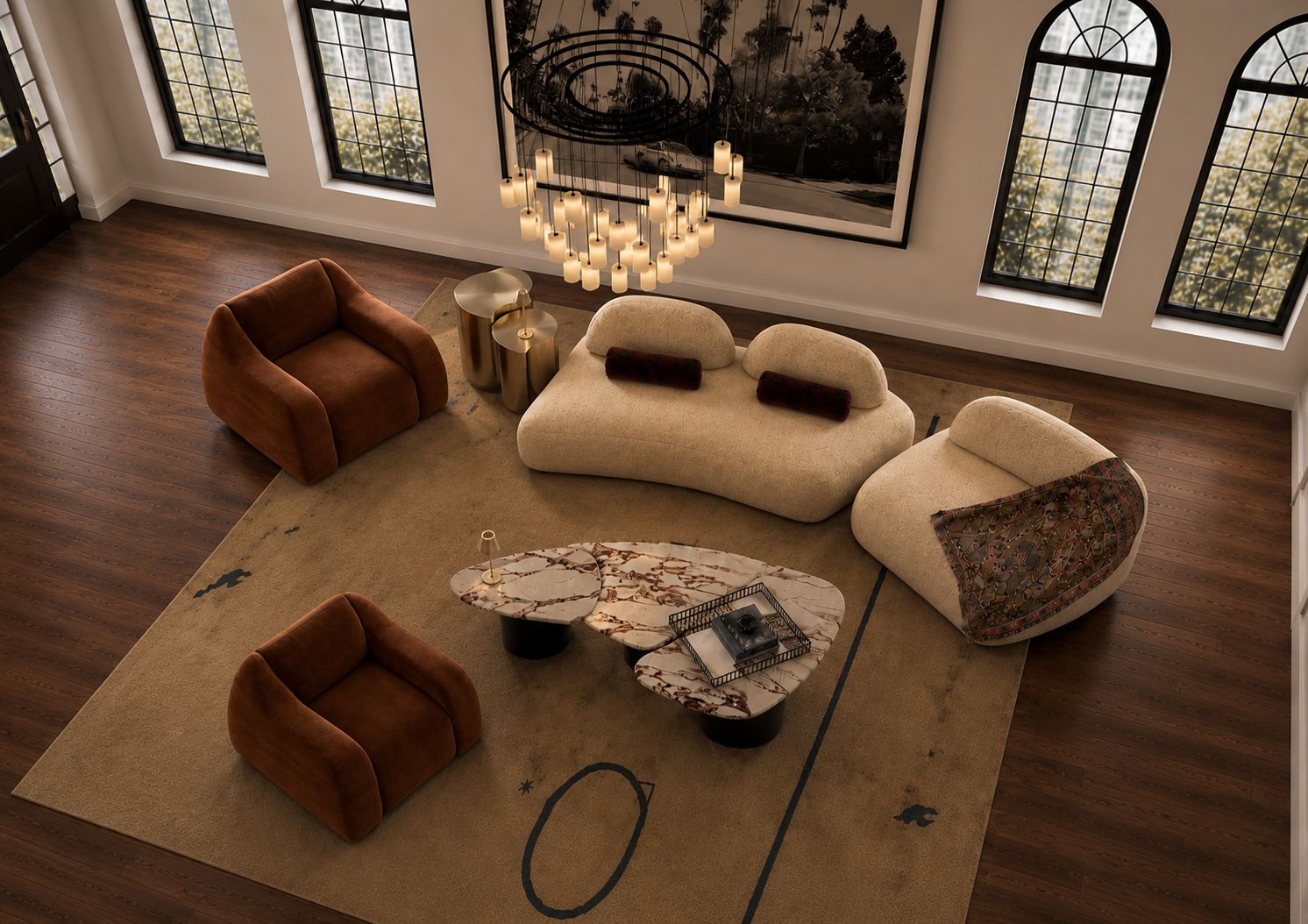 An overhead view of an open living room with terracotta armchairs, curved cream sofas and marble coffee tables on a layered rug over dark timber floors.